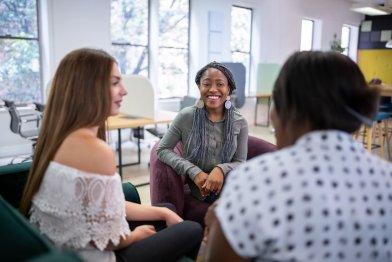 Lady speaking with a male and female at a support session